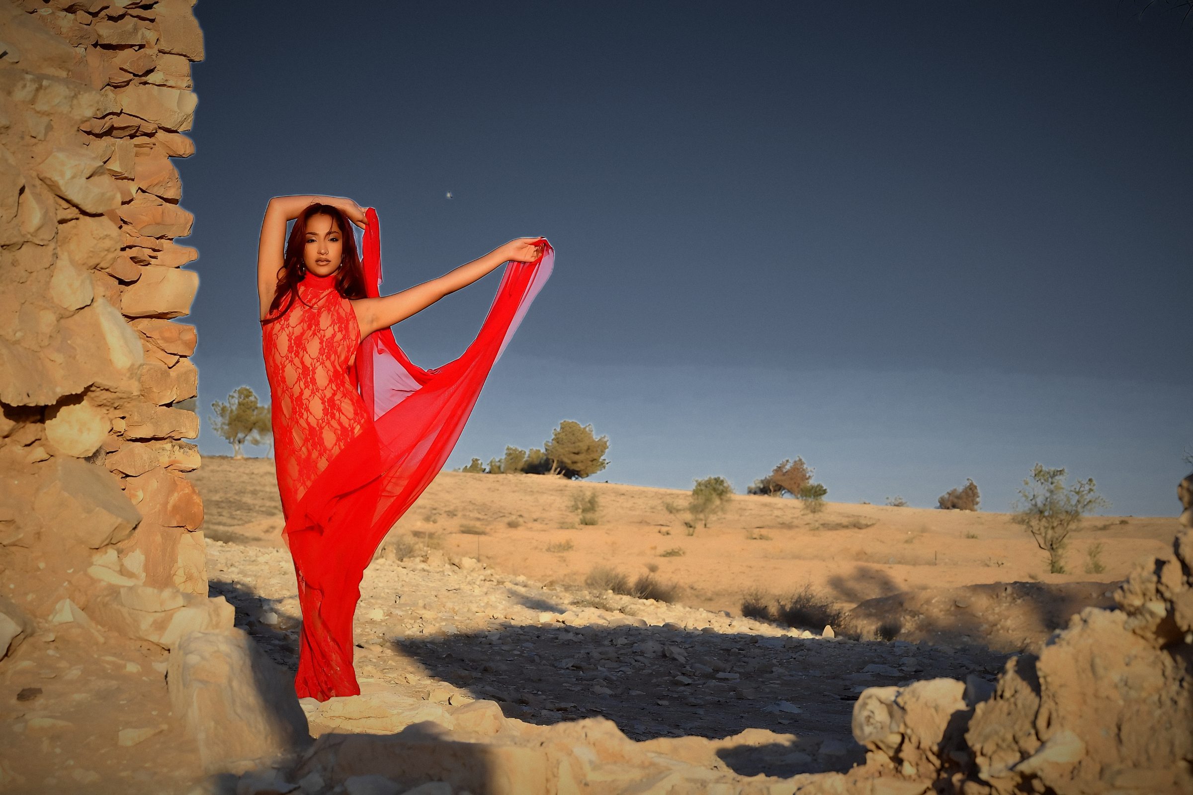Daniel De Loco, red dress and scarf, desert ruins